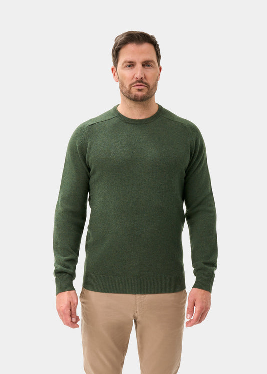 Man wearing Dorset Lambswool Crew Neck Jumper in Rosemary, classic fit, against a plain white background.