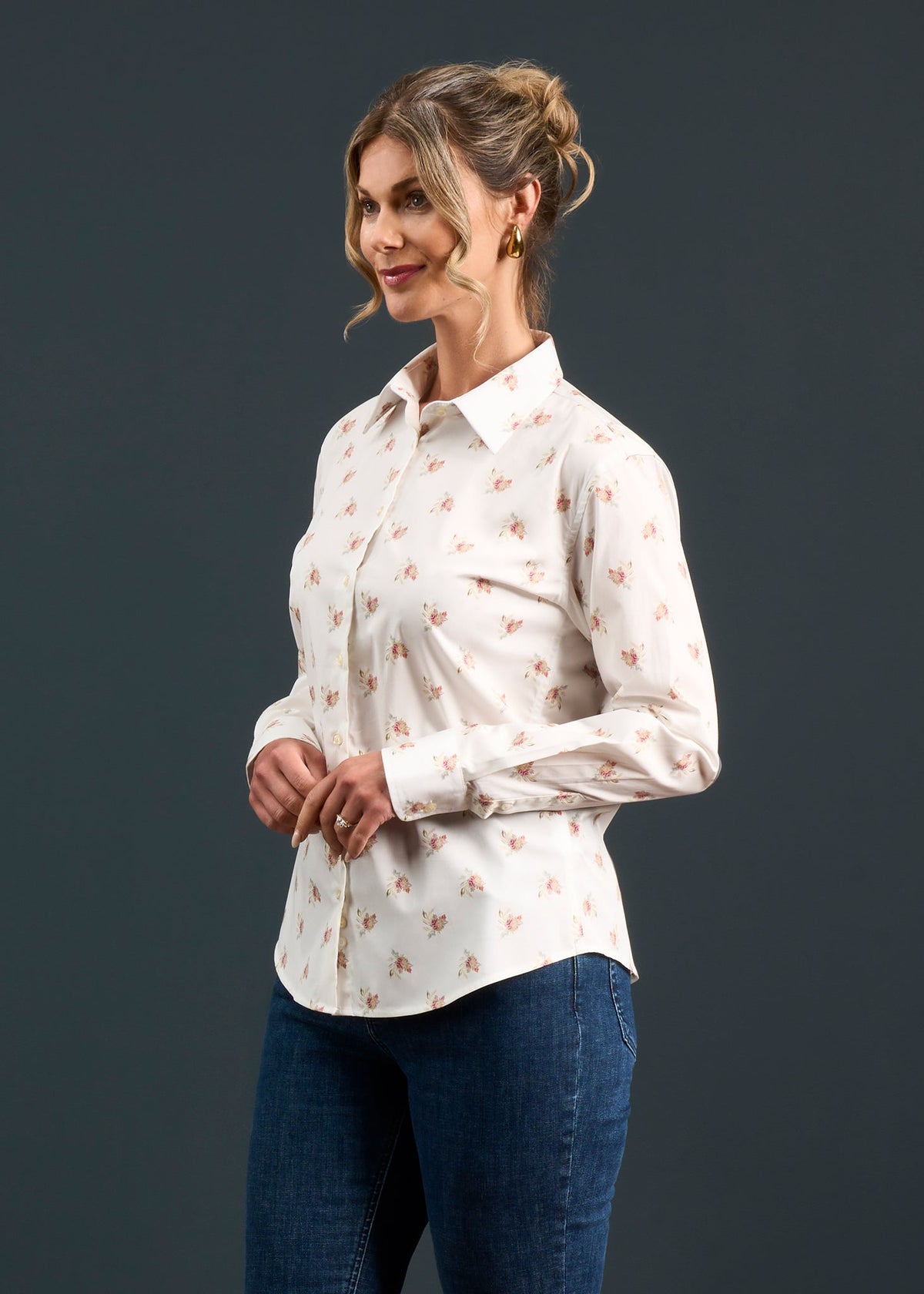 Woman wears the Lawen Cotton Printed Shirt in Floral Print, smiling against a dark gray background.