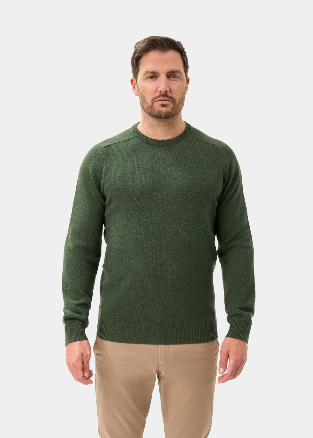 Man wearing Dorset Lambswool Crew Neck Jumper in Rosemary, classic fit, against a plain white background.