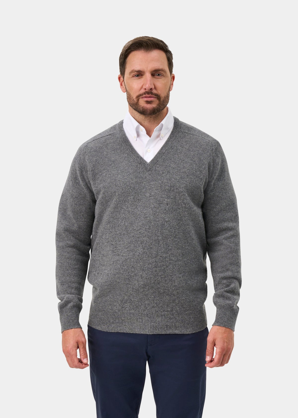 Man in Hampshire Lambswool V-Neck Jumper in Grey Mix, classic fit, over white shirt and navy pants.