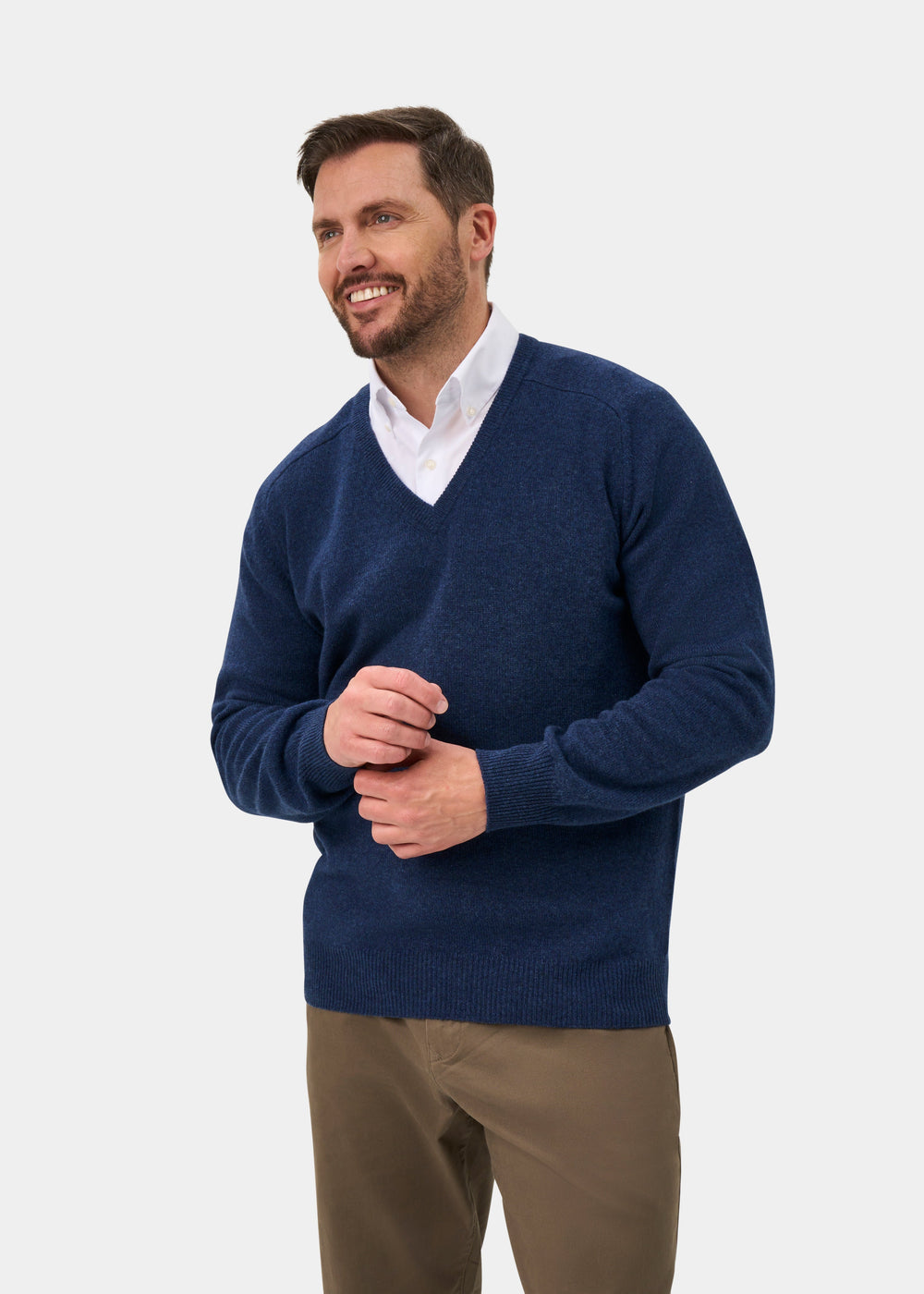 Man in Hampshire Lambswool V-Neck Jumper in Rhapsody, classic fit, paired with khaki pants on a neutral background.