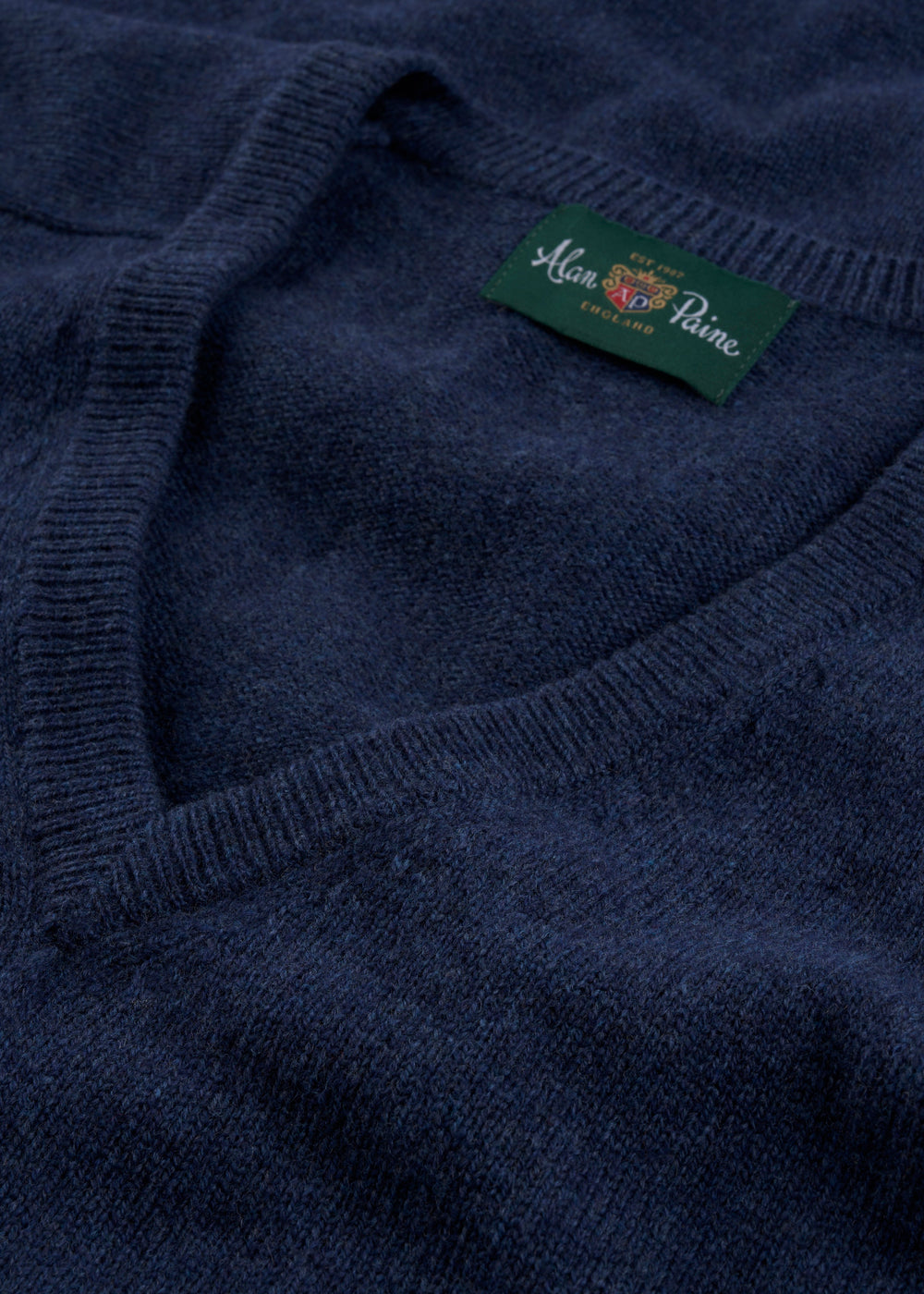 Close-up of the Hampshire Lambswool V-Neck Jumper in Rhapsody, classic fit, with Alan Paine label inside collar.