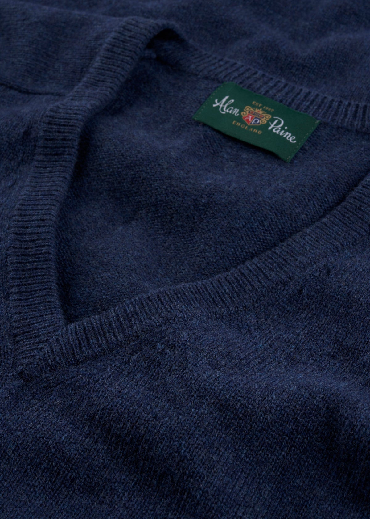 Close-up of the Hampshire Lambswool V-Neck Jumper in Rhapsody, classic fit, with Alan Paine label inside collar.