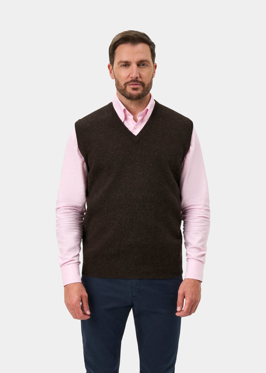 A man wearing a Norfolk Lambswool V-Neck Slipover In Cocoa over a light pink button-down shirt.