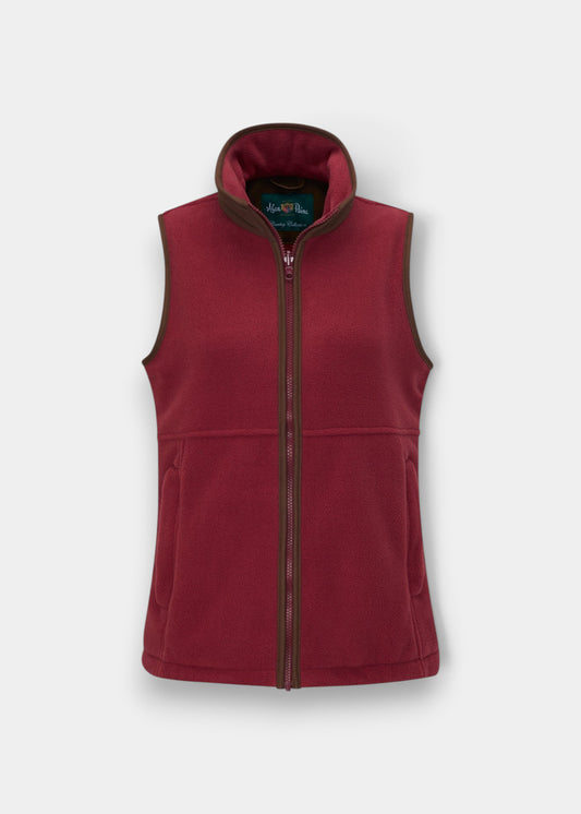 Alan Paine children's cranberry fleece waistcoat with brown mock suede trim, front zip, and adjustable waist.
