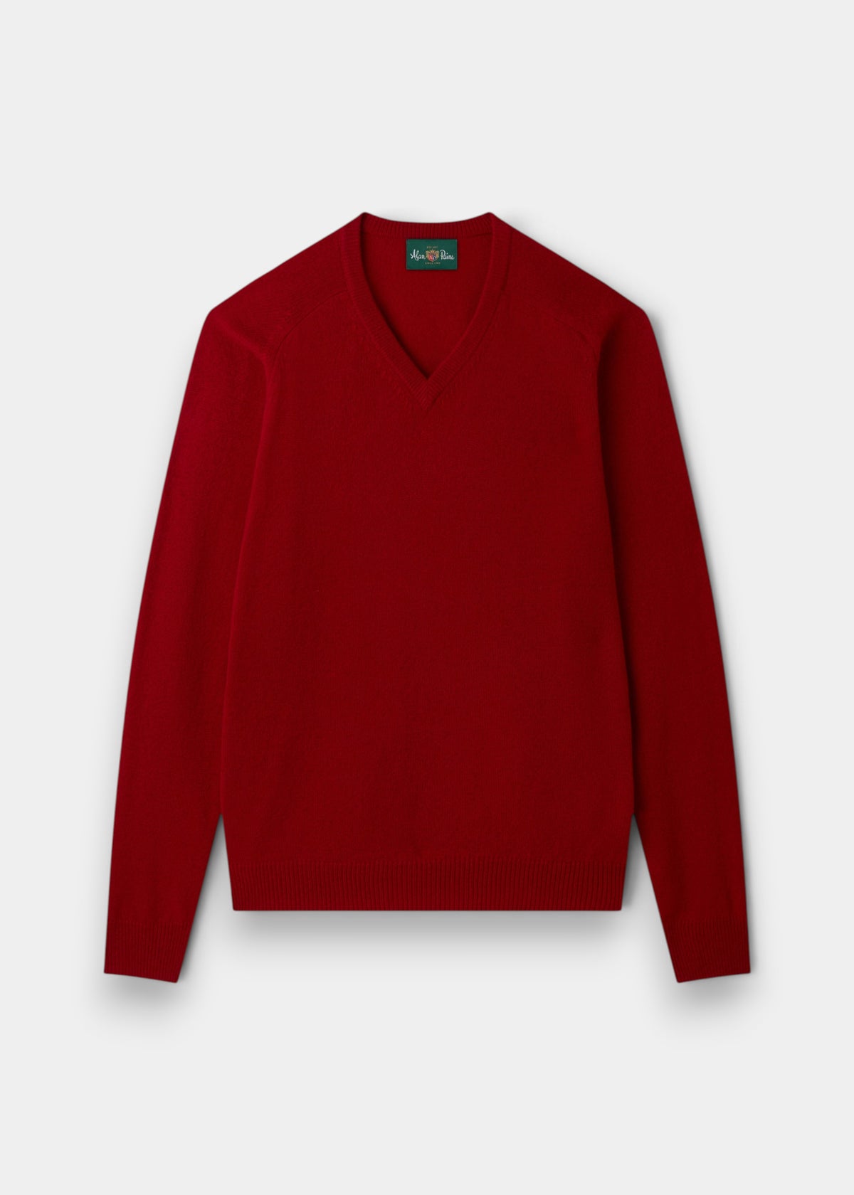 The Kilsyth Lambswool V-Neck Jumper in Dubonnet is shown laid flat on a light gray background.
