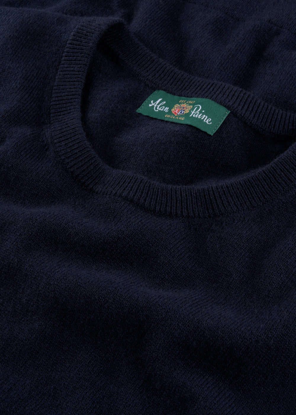 Ivy Wool & Cashmere Crew Neck Jumper in dark navy, features a green Alan Paine label on the collar, laid flat.