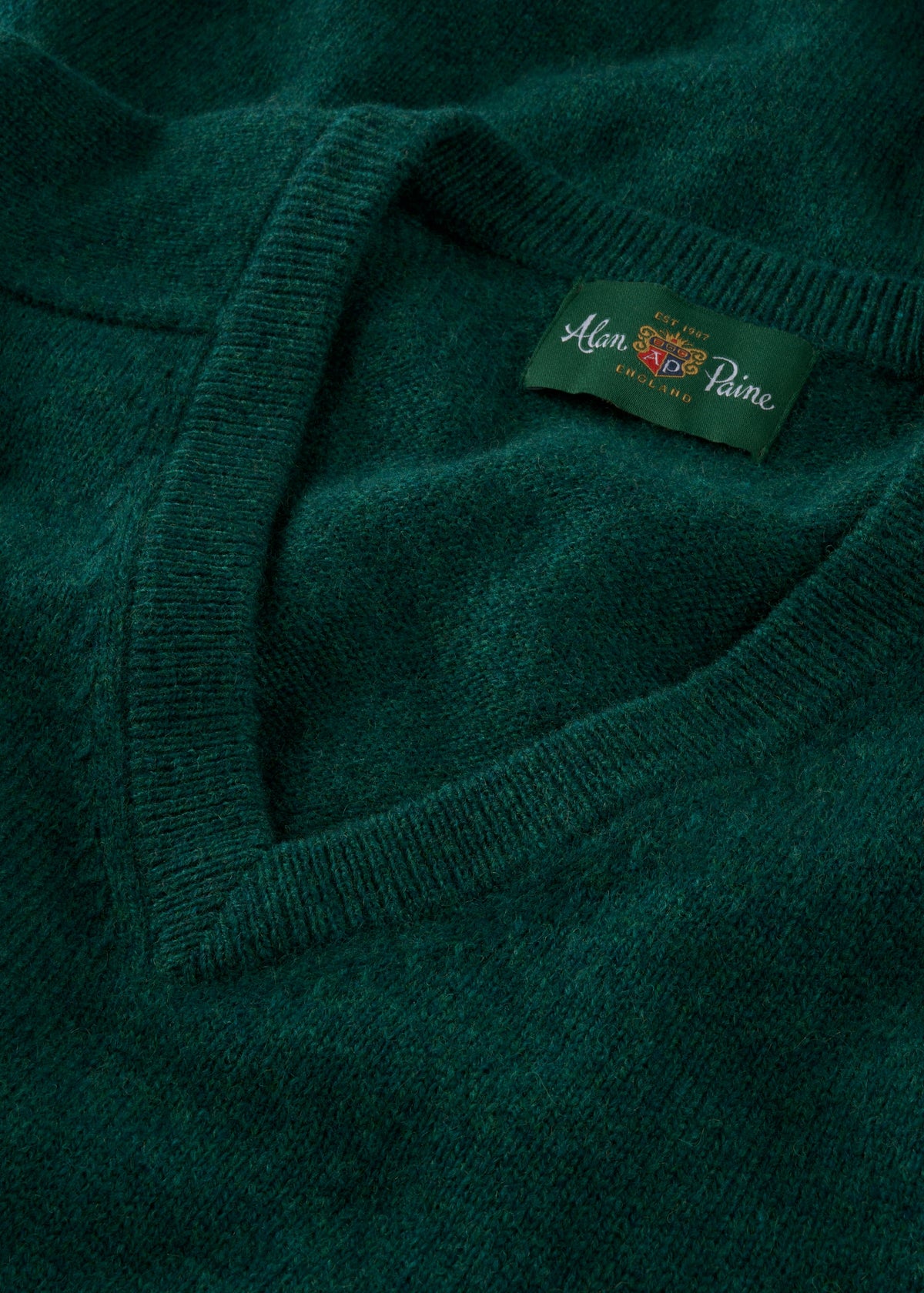 Close-up of Kilsyth Lambswool V-Neck Jumper in Mallard, regular fit, with Alan Paine label on inside collar.