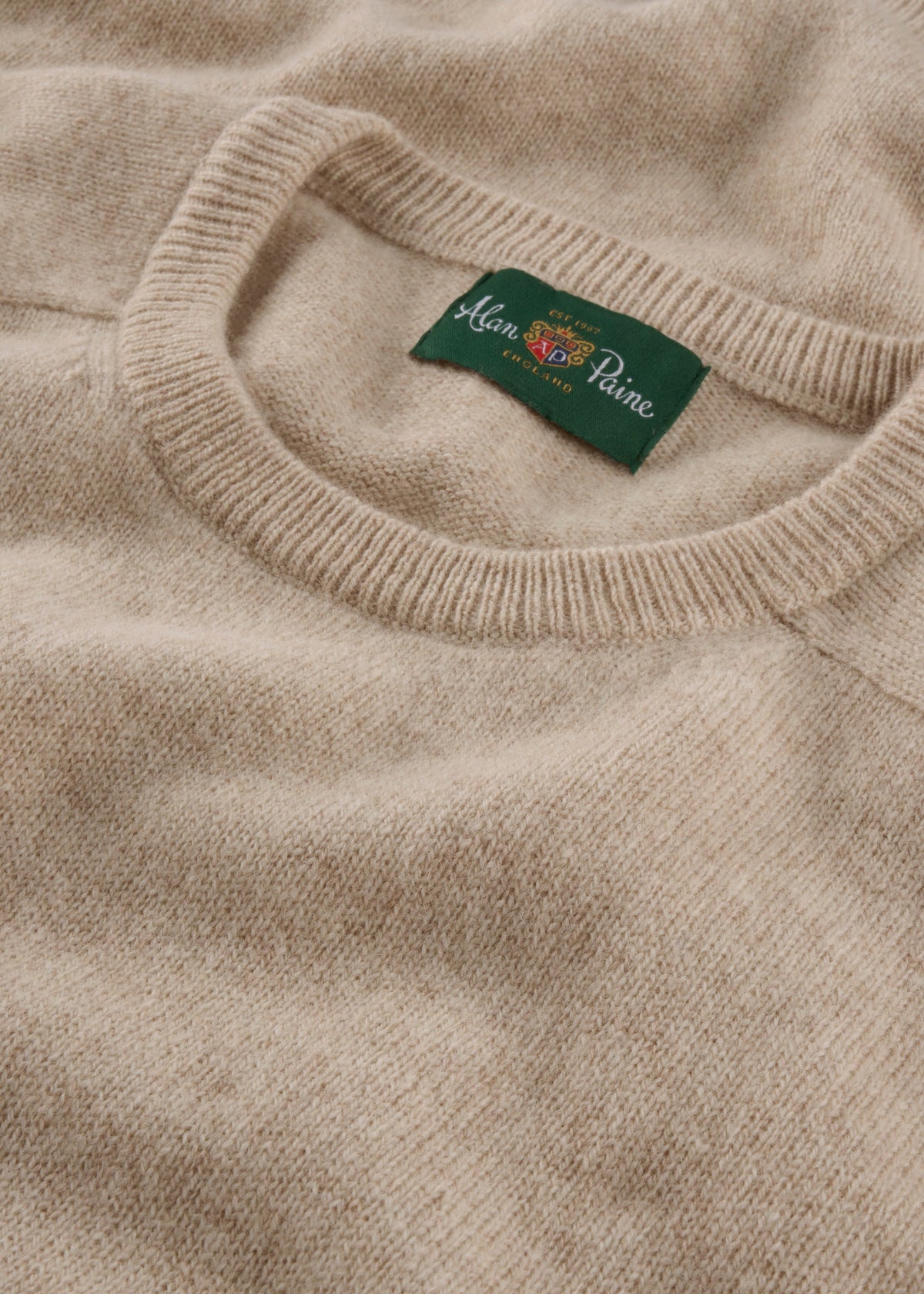 A linen Lenzie Lambswool Crew Neck Jumper, regular fit, laid flat to show the collar and brand tag.